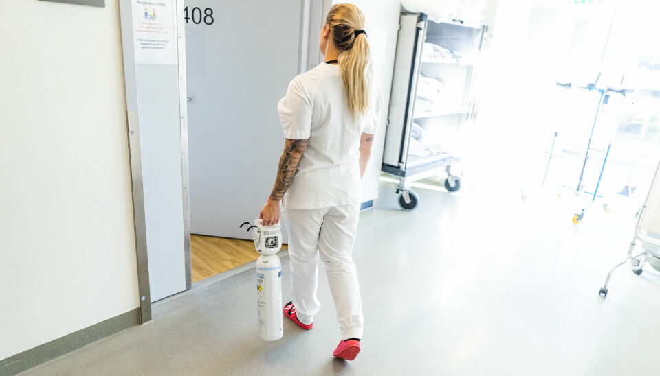 En sykepleier bringer en ny oksygenflasker til en lungepasient på Ahus på Lørenskog.