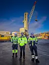 Gruppebilde med kran i bakgrunnen.