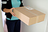 Woman picking up a parcel at her flat