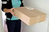 Woman picking up a parcel at her flat